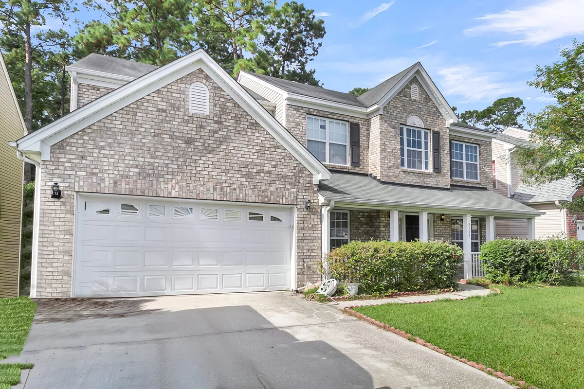 A welcoming brick facade with large windows, a front porch, and a landscaped garden. The setting suggests a space ideal for gathering outdoors, with plenty of room for socializing and enjoying the fresh air.