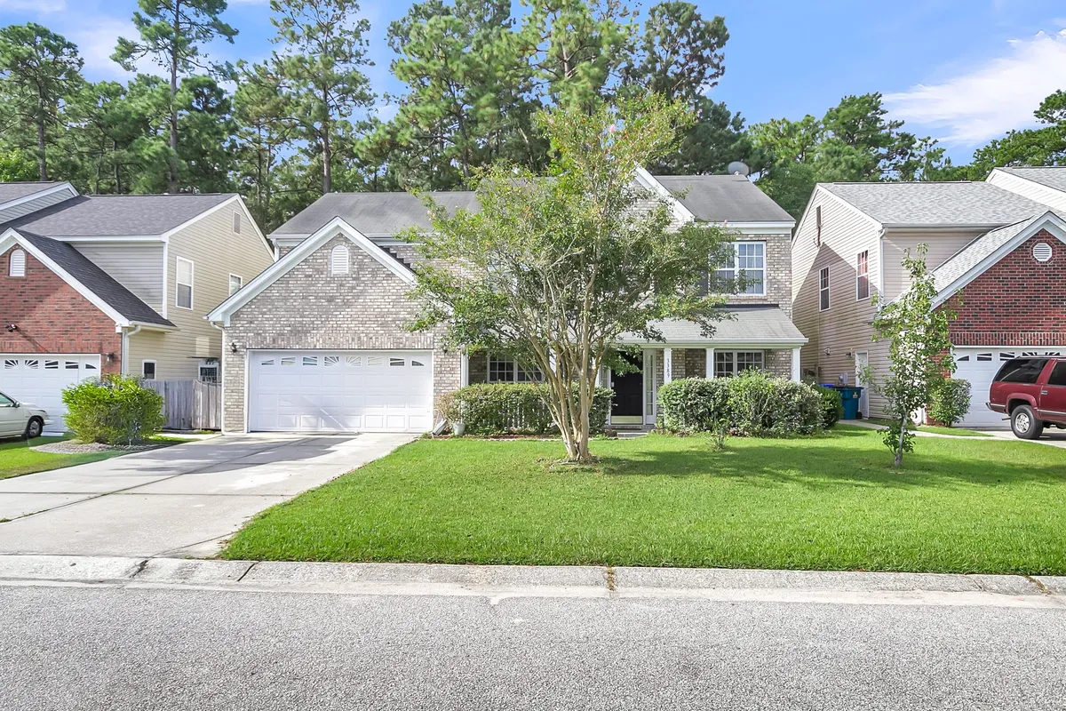 This exterior image captures the home's welcoming facade, front yard with a mature tree, and driveway, conveying the sense of arrival and the friendly neighborhood atmosphere. The overall vibe is warm and inviting, ideal for business travelers or those relocating who are seeking a comfortable long-term base.